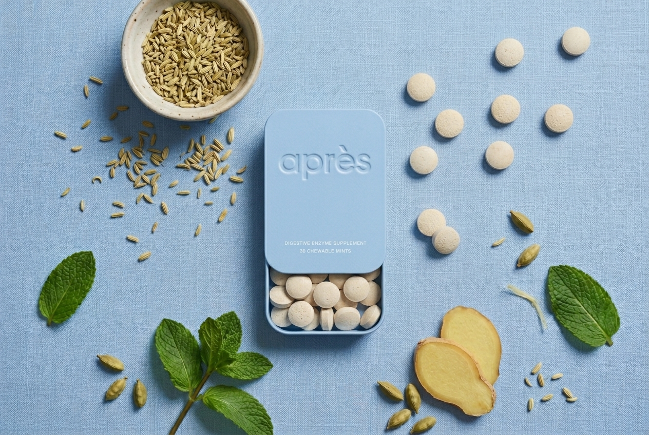 Après digestive enzyme mints arranged beside the open tin, mint leaves, ginger and fennel